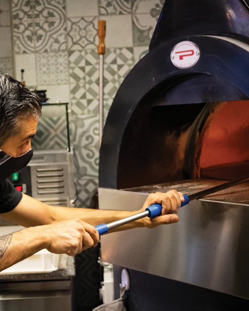 Pizzaiolo inforna pizza in forno Pavesi